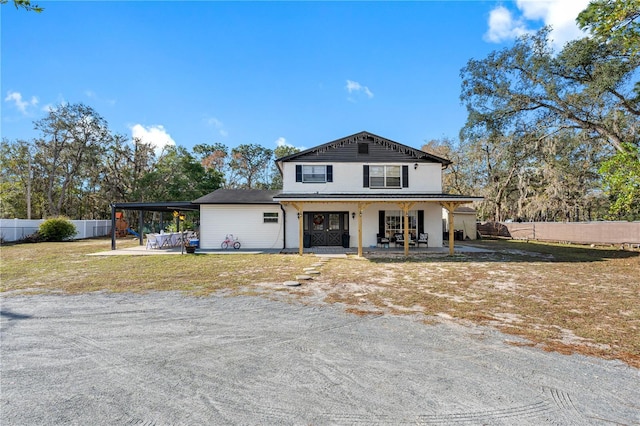 view of front facade featuring a carport and a front lawn