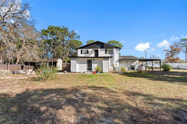 rear view of property with a yard and a shed