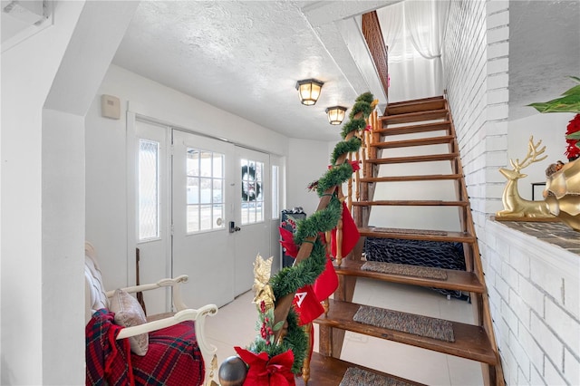 stairway with a textured ceiling