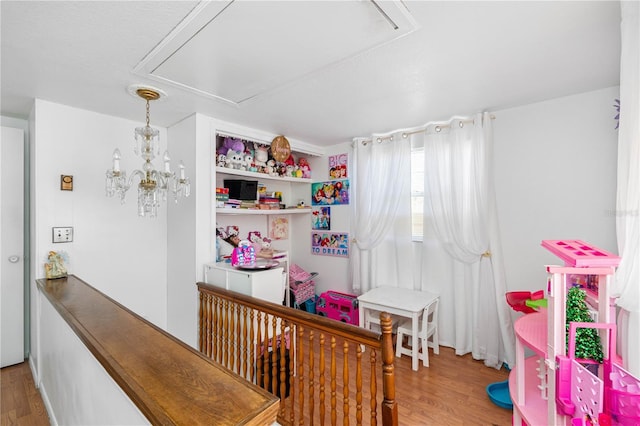 bedroom featuring a crib and wood-type flooring