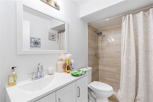 bathroom with vanity, toilet, and curtained shower