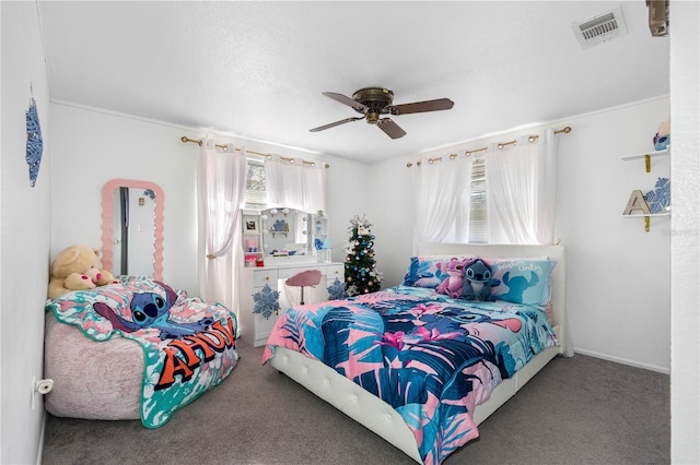 bedroom with carpet flooring, ceiling fan, and crown molding