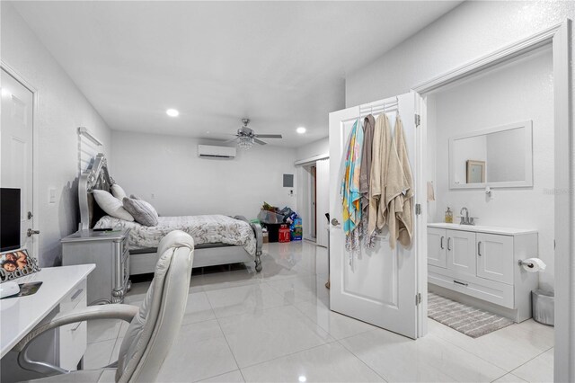 bedroom with ceiling fan, light tile patterned floors, sink, and a wall mounted AC