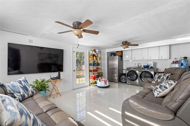 tiled living room with a textured ceiling, separate washer and dryer, and ceiling fan