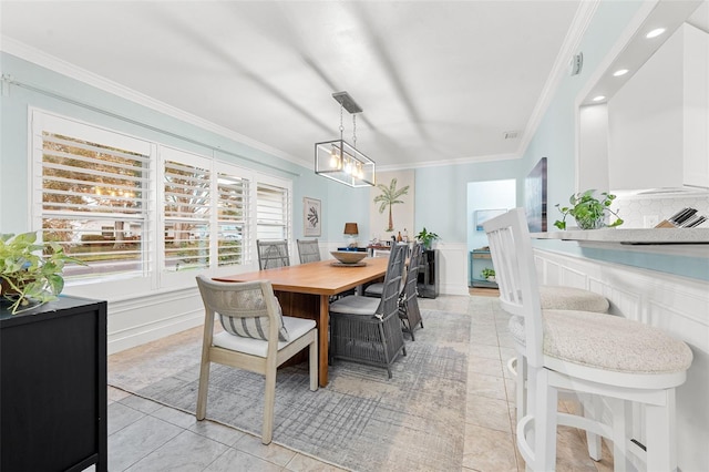 tiled dining room with ornamental molding