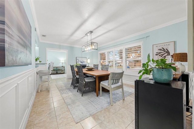 dining room featuring light tile patterned floors and ornamental molding