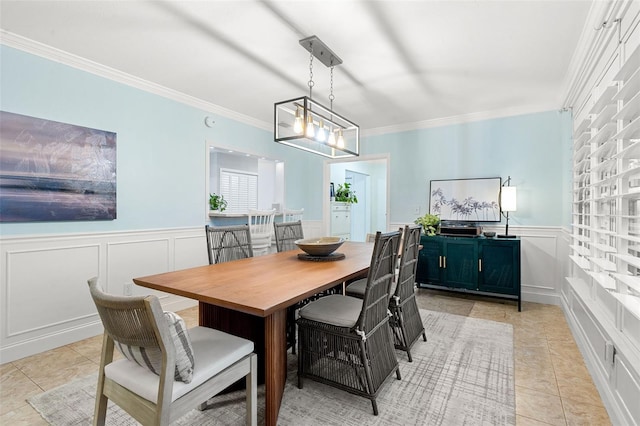 tiled dining room featuring a chandelier and ornamental molding