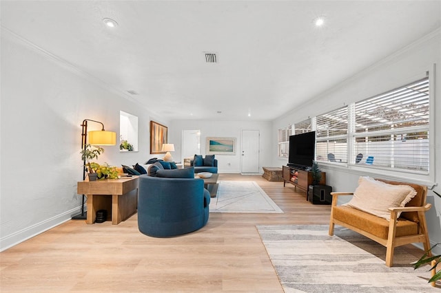 living room featuring light hardwood / wood-style floors and crown molding