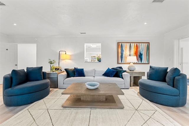 living room featuring light wood-type flooring and crown molding