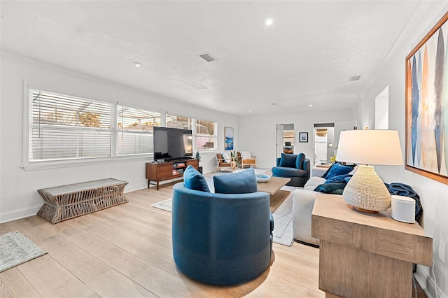 living room featuring light hardwood / wood-style floors and ornamental molding