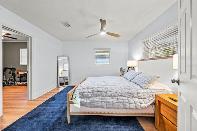 bedroom featuring hardwood / wood-style flooring and ceiling fan