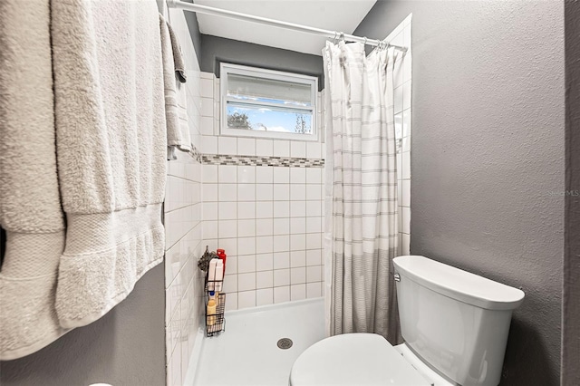 bathroom with toilet and walk in shower