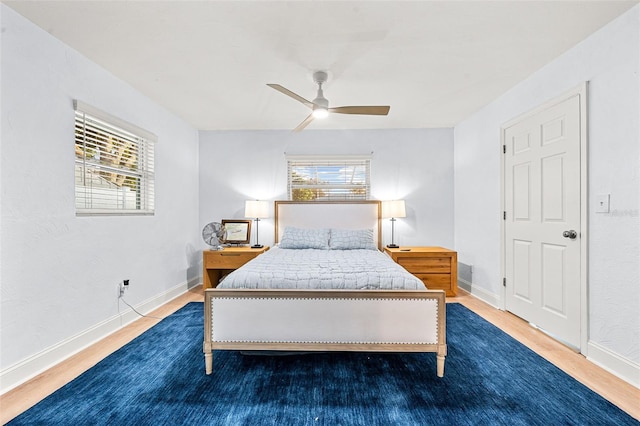 bedroom with dark hardwood / wood-style floors and ceiling fan