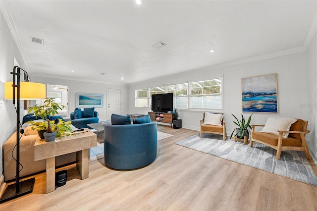 living room with light hardwood / wood-style floors and ornamental molding