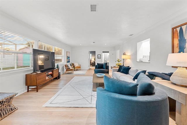 living room with light hardwood / wood-style floors and ornamental molding