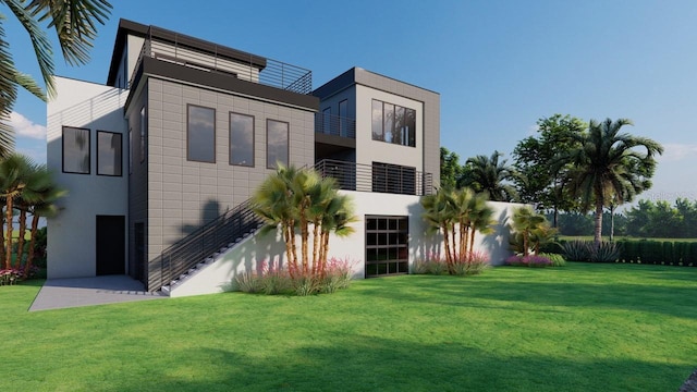 rear view of house with stucco siding, stairway, and a yard