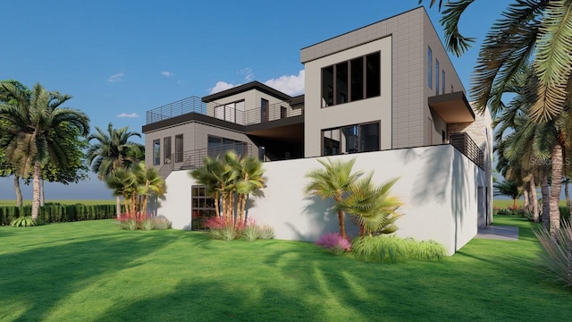 back of property with a lawn, a balcony, and stucco siding