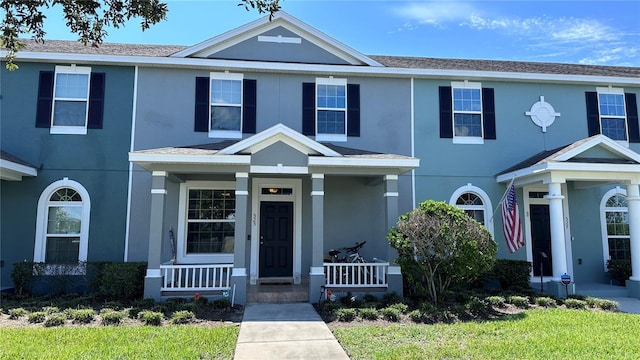 view of front of house with a porch and stucco siding