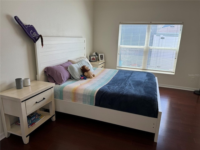 bedroom featuring dark wood-style flooring and baseboards