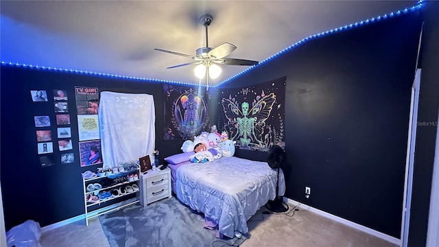 carpeted bedroom with ceiling fan and baseboards