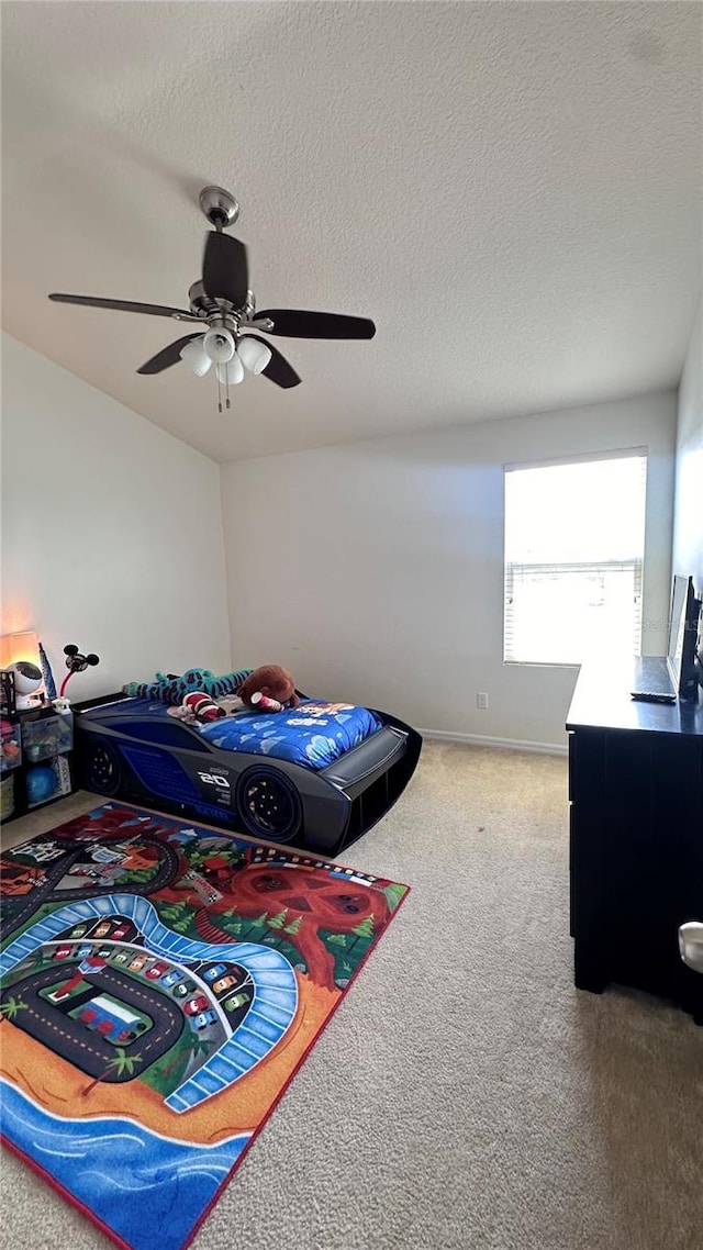 bedroom featuring a ceiling fan, carpet flooring, a textured ceiling, and baseboards