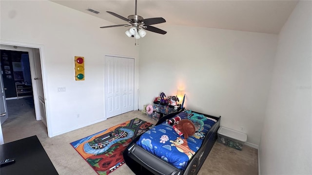 carpeted bedroom with lofted ceiling, baseboards, visible vents, and a closet