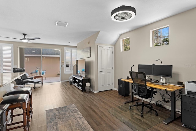 home office with ceiling fan, dark hardwood / wood-style flooring, and lofted ceiling