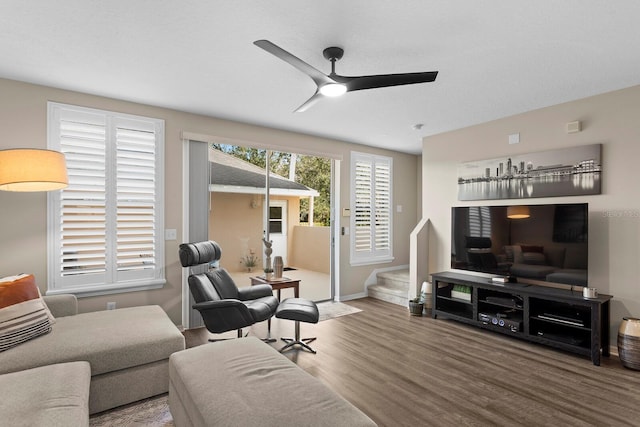 living room featuring ceiling fan and hardwood / wood-style floors