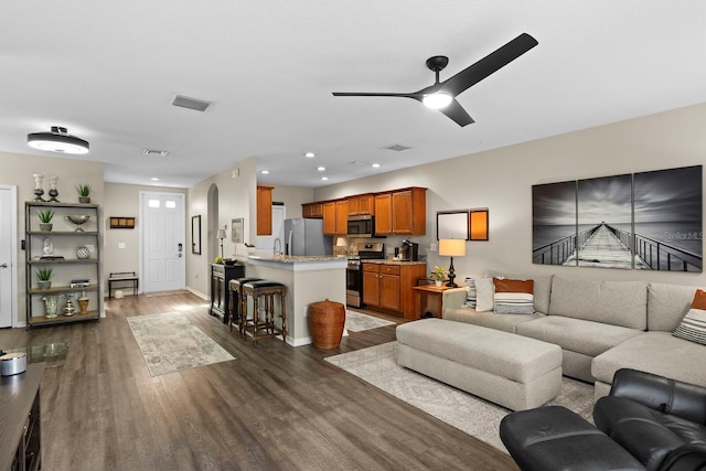 living room featuring dark hardwood / wood-style floors and ceiling fan