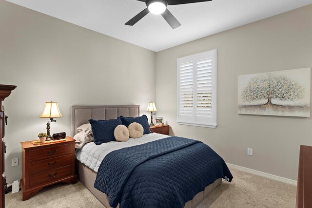 bedroom featuring light carpet and ceiling fan