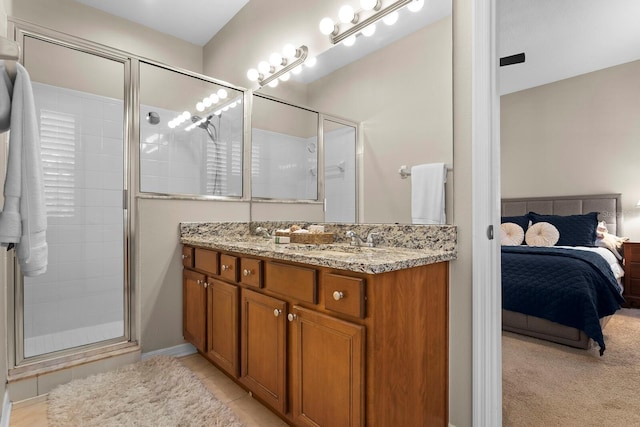 bathroom with vanity and a shower with door