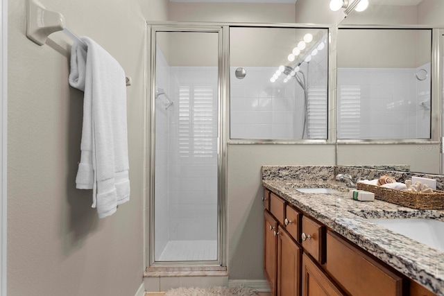 bathroom featuring vanity and a shower with shower door