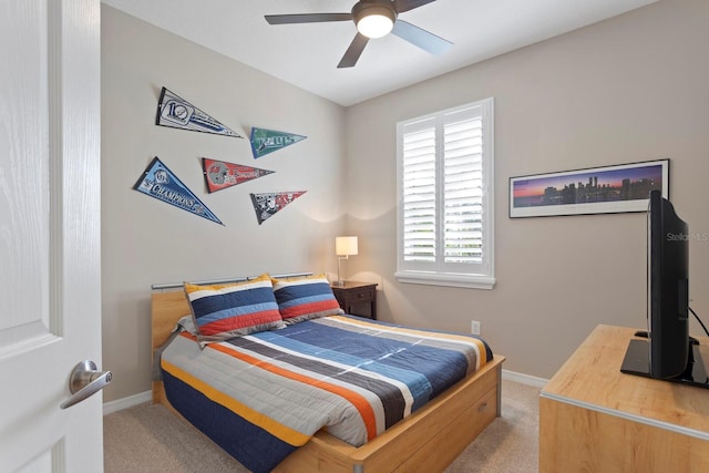 carpeted bedroom with multiple windows and ceiling fan