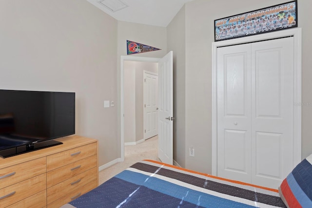 bedroom with light colored carpet and a closet