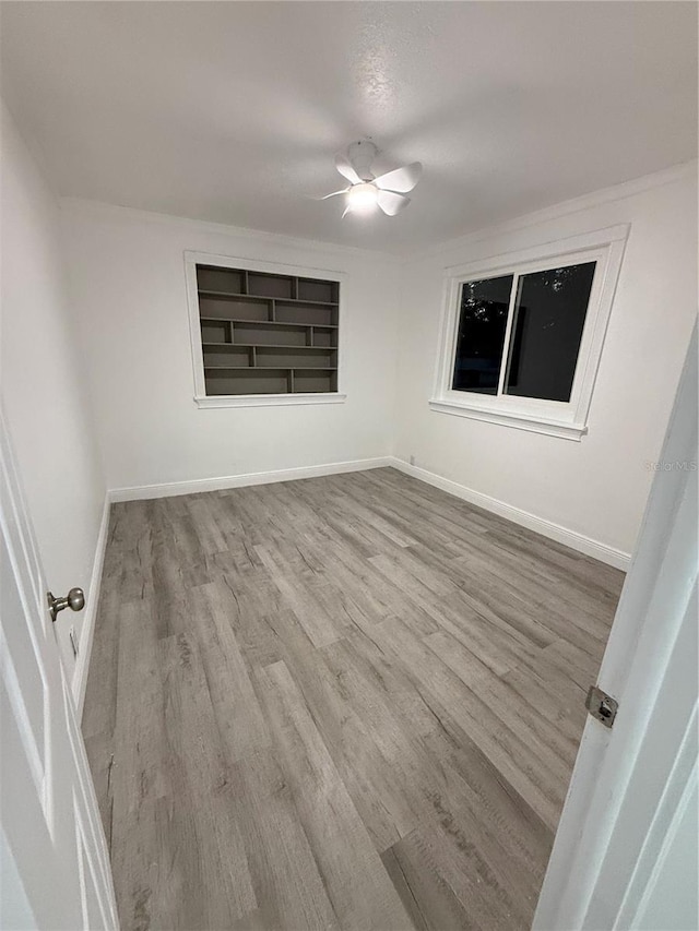 unfurnished room featuring ceiling fan and light hardwood / wood-style flooring