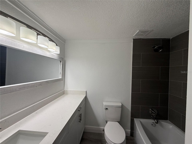 full bathroom featuring crown molding, tiled shower / bath combo, vanity, a textured ceiling, and toilet