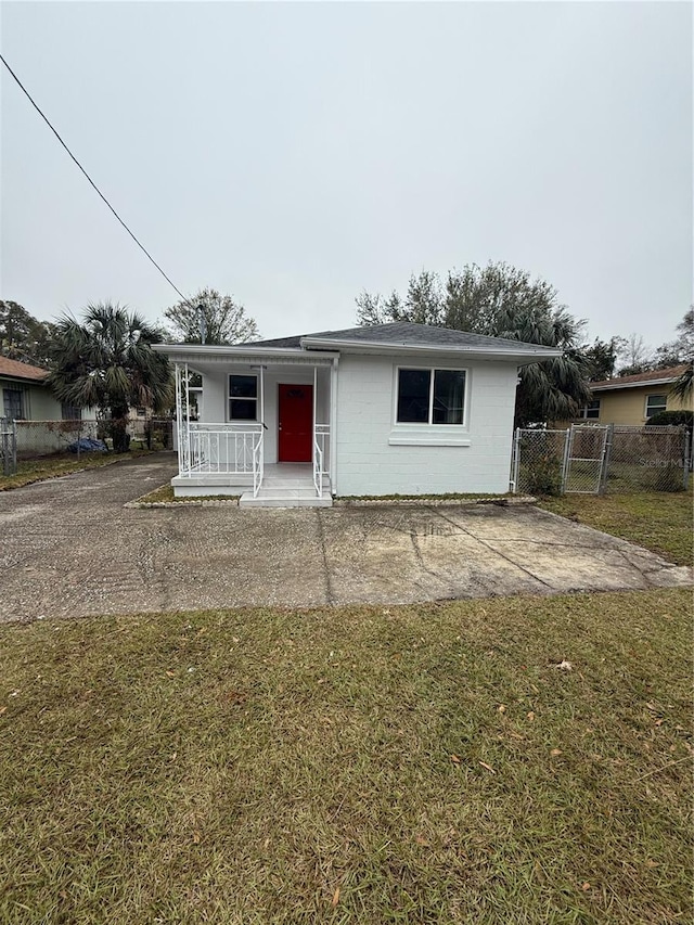 ranch-style home with a porch and a front lawn