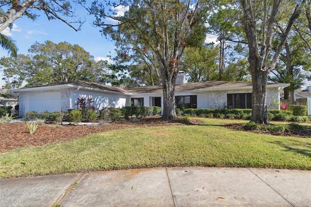 single story home with a garage and a front lawn