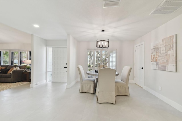 dining space with a chandelier