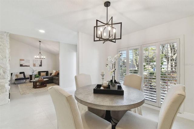 dining space with vaulted ceiling and a notable chandelier