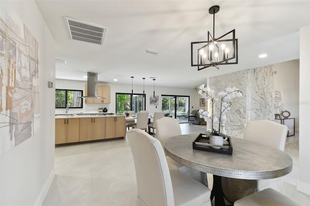 dining space featuring a chandelier and sink