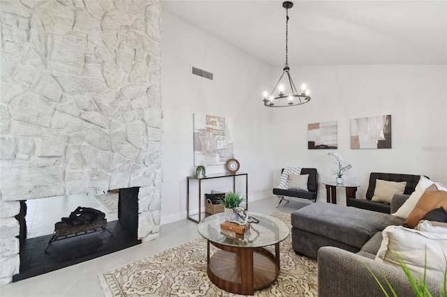 living room with a stone fireplace, lofted ceiling, and a notable chandelier