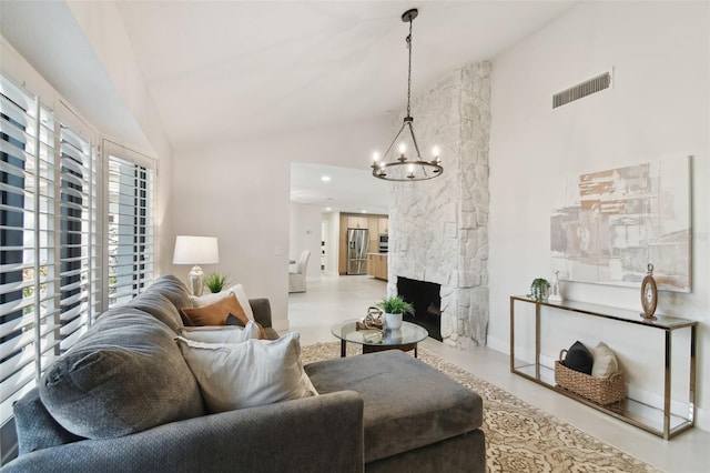 living room featuring a fireplace, high vaulted ceiling, and a chandelier