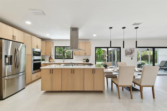 kitchen featuring light brown cabinets, stainless steel appliances, pendant lighting, island range hood, and a kitchen island