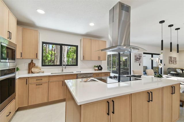 kitchen featuring light brown cabinetry, island range hood, and sink