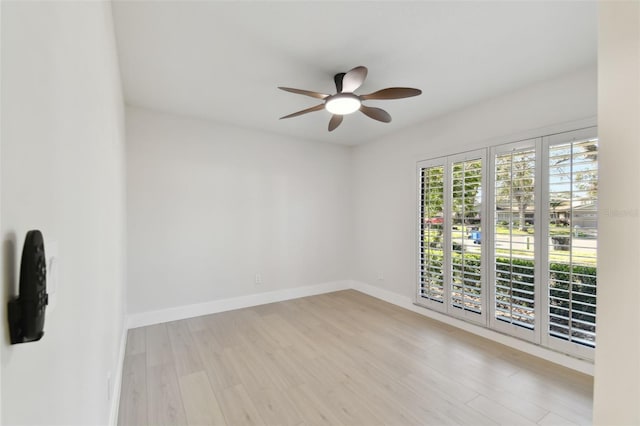 empty room with ceiling fan and light hardwood / wood-style floors