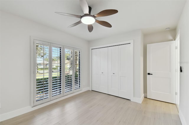 unfurnished bedroom featuring ceiling fan, light hardwood / wood-style flooring, and a closet