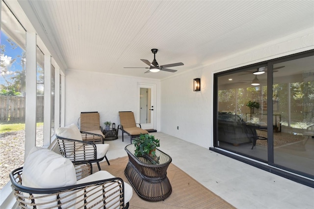 sunroom / solarium featuring ceiling fan