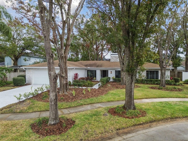 ranch-style house featuring a garage and a front yard