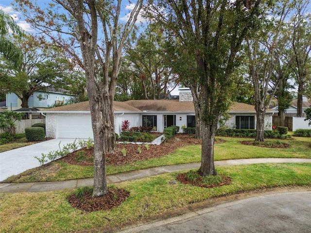 view of front of property with a front yard and a garage